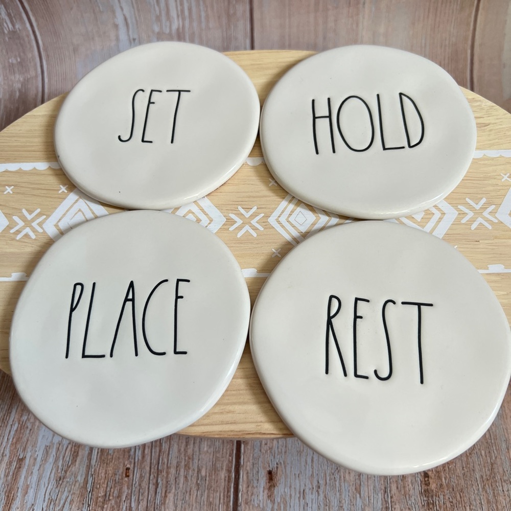 NWOT Rae Dunn 4 piece whit & black coaster set. 4” in diameter.
